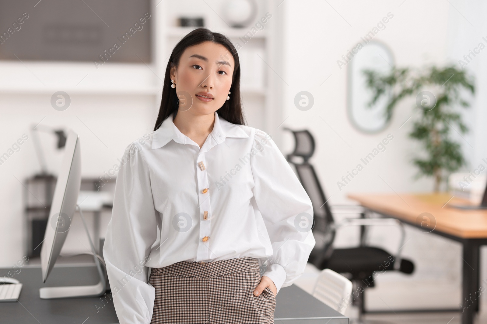 Photo of Portrait of beautiful businesswoman in office. Space for text