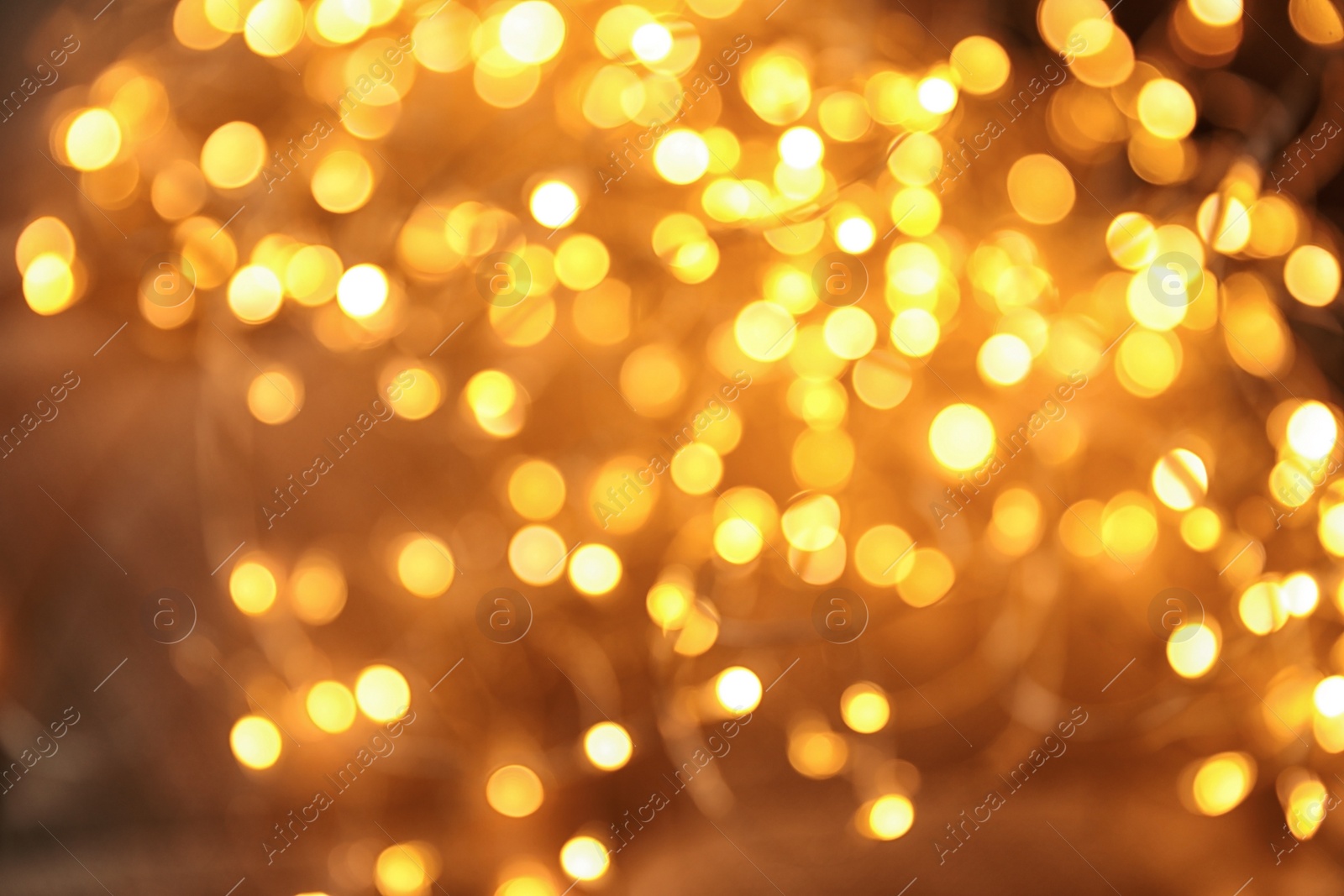 Photo of Gold glitter with bokeh effect on dark background