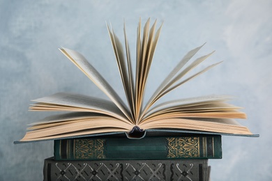 Stack of hardcover books on light blue background