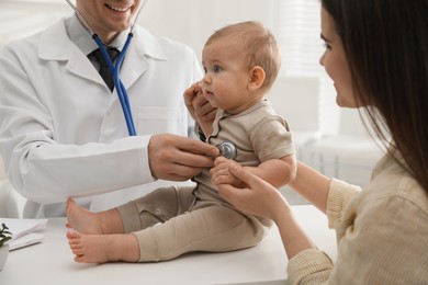 Photo of Mother with her cute baby visiting pediatrician in clinic