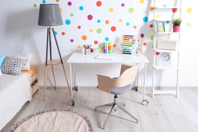 Photo of Modern child room interior with desk and bed