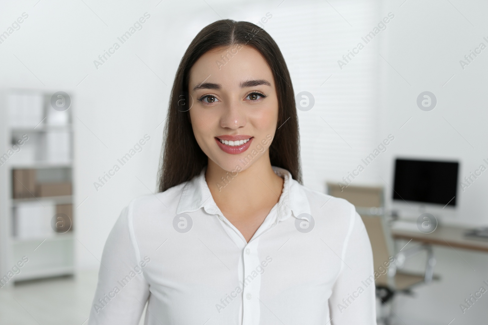 Photo of Portrait of beautiful young woman in office