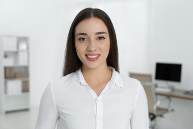 Portrait of beautiful young woman in office