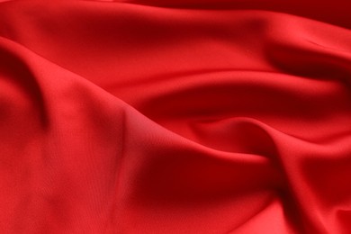 Crumpled red silk fabric as background, closeup