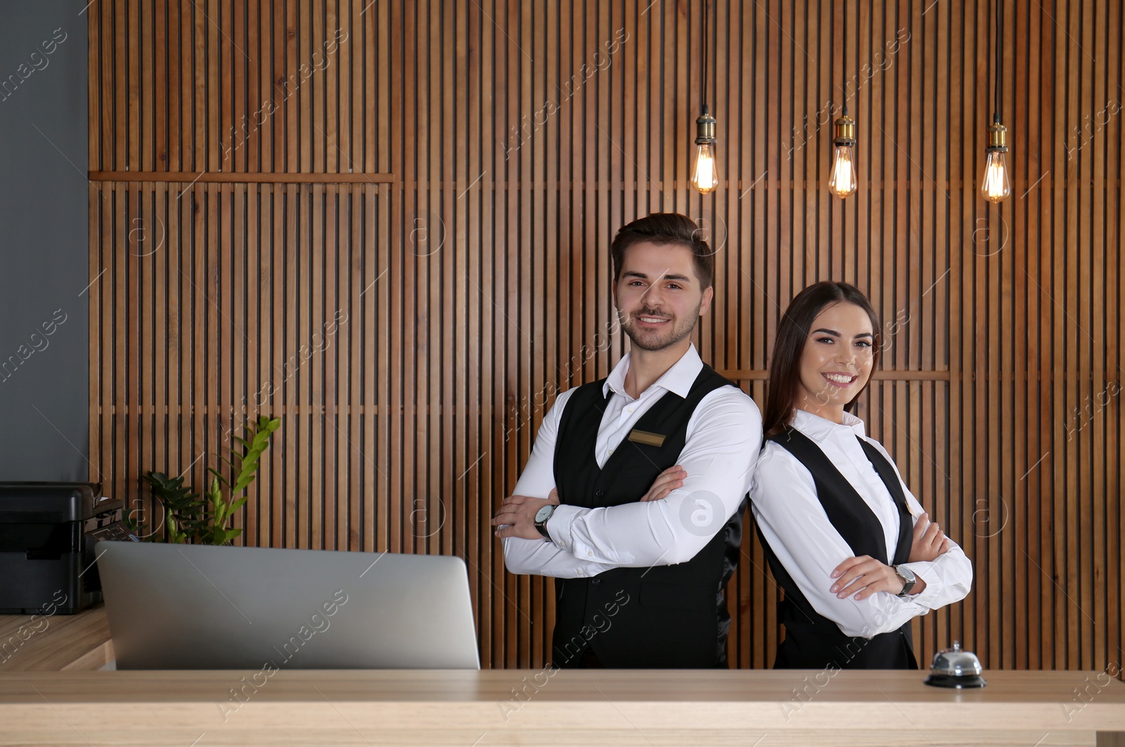 Photo of Smiling receptionists at desk in modern lobby