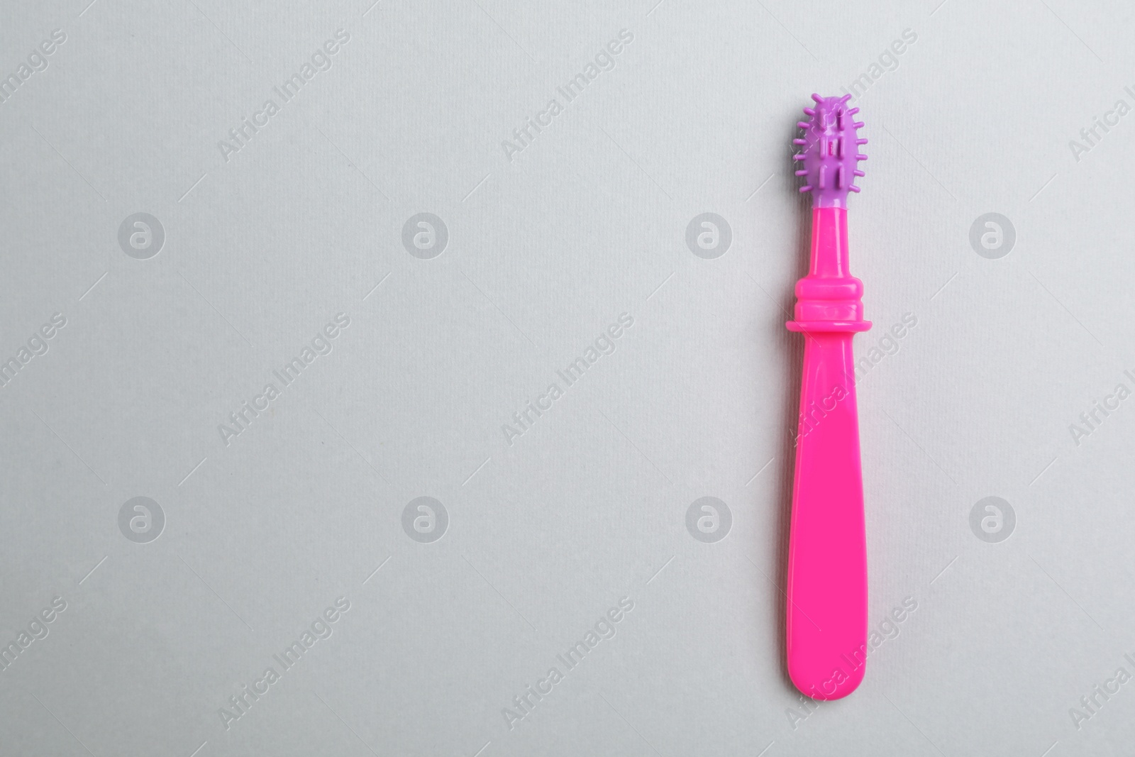 Photo of Manual toothbrush for child on gray background, top view with space for text