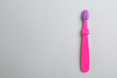 Manual toothbrush for child on gray background, top view with space for text