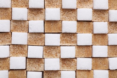 Photo of White and brown sugar cubes as background, top view