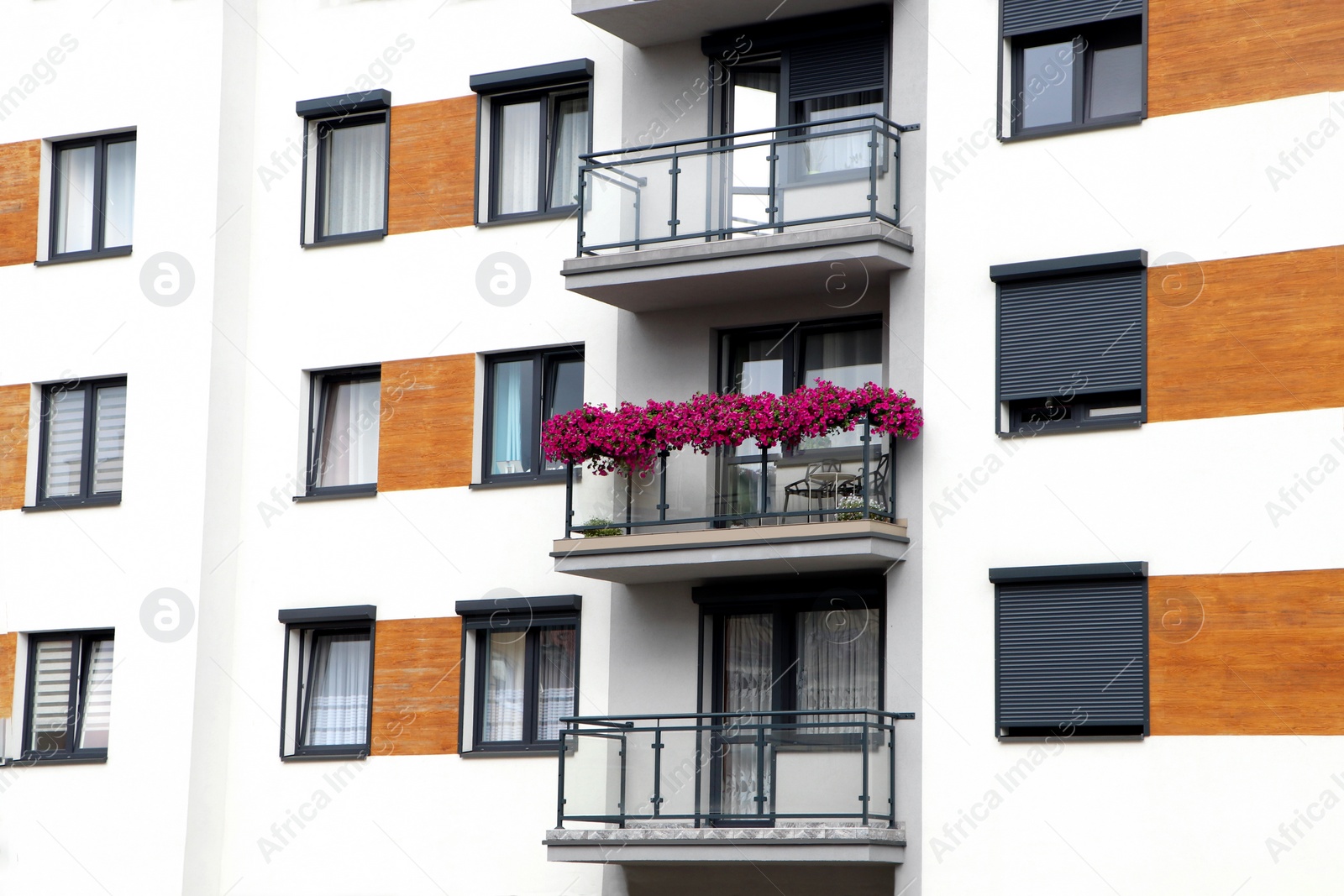 Photo of Beautiful view of building with balconies and windows