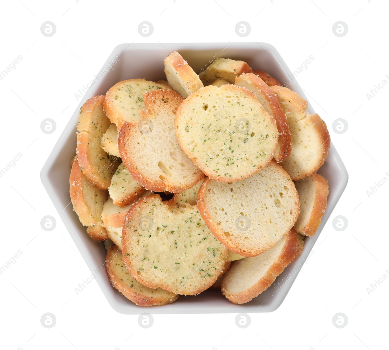 Photo of Crispy rusks with seasoning in bowl isolated on white, top view