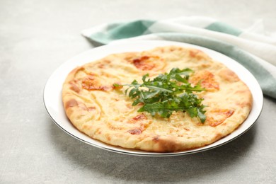 Delicious khachapuri with cheese served on light table