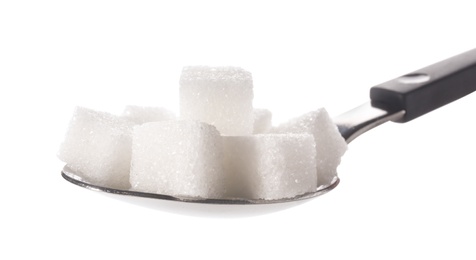 Photo of Refined sugar cubes in spoon on white background