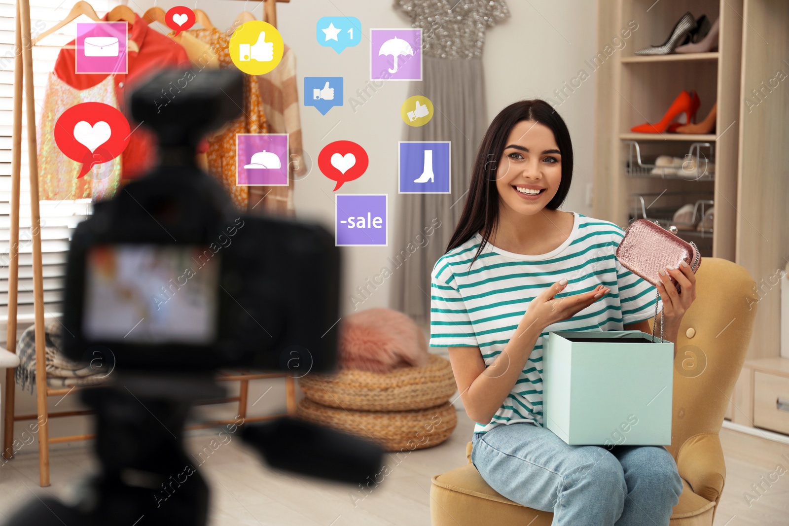 Image of Young fashion blogger recording video in room