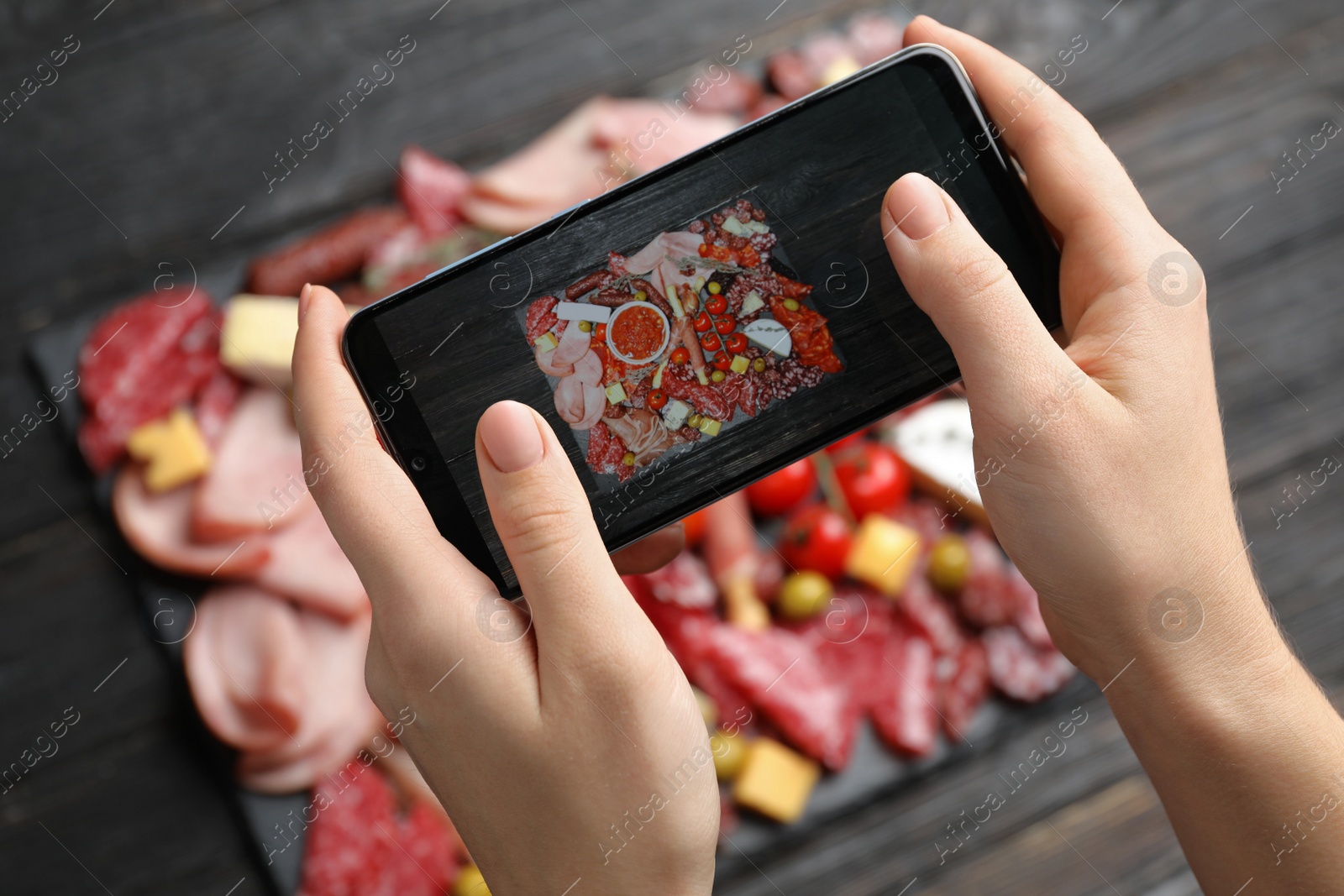 Photo of Blogger taking picture of food at table, closeup