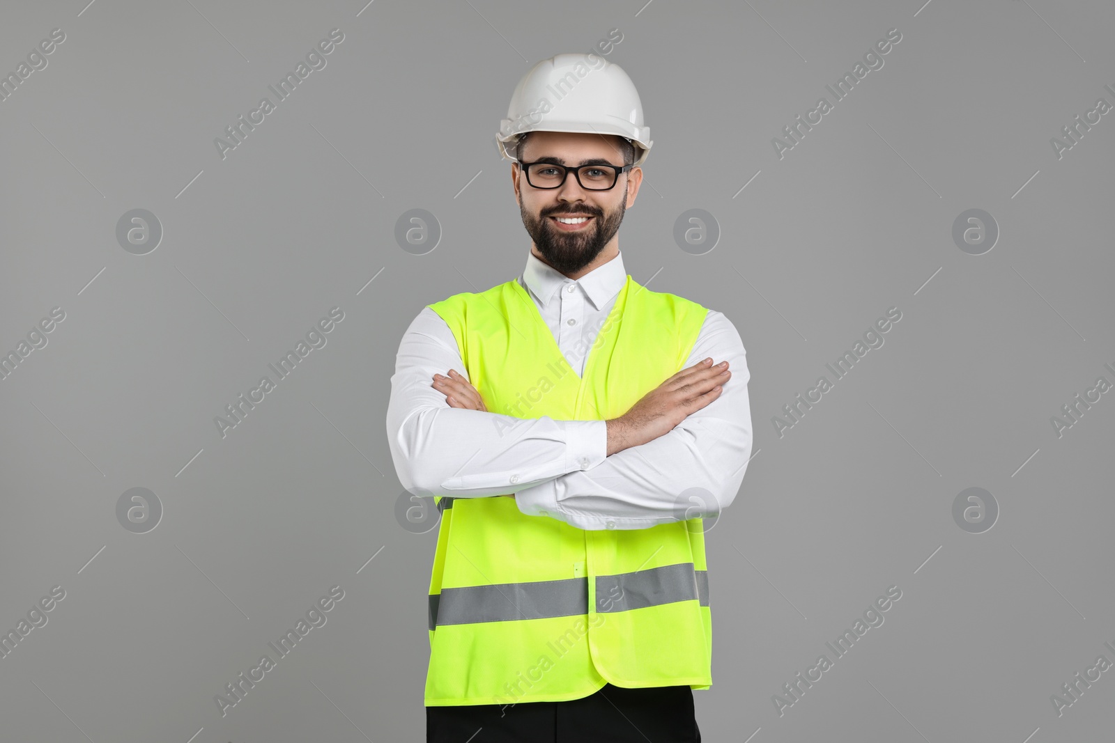 Photo of Engineer in hard hat on grey background