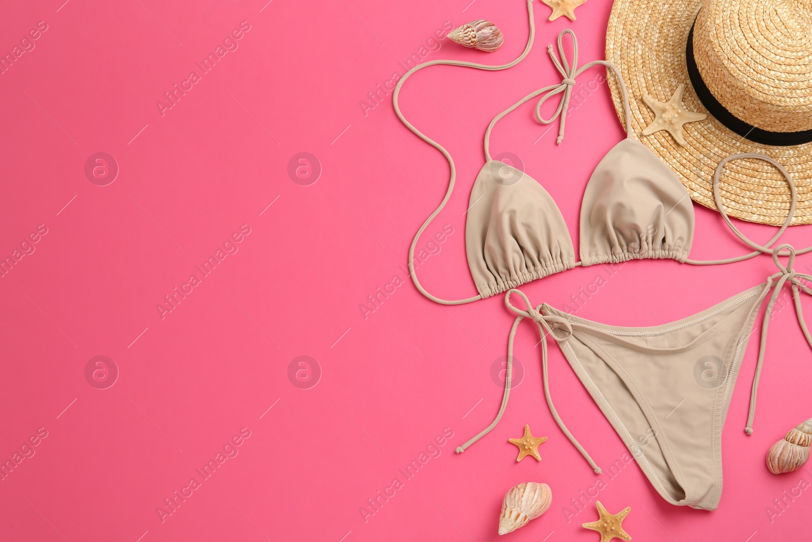 Photo of Flat lay composition with stylish bikini on pink background. Space for text