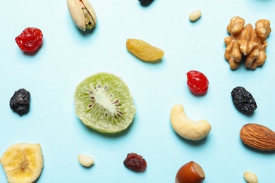 Flat lay composition of different dried fruits and nuts on color background