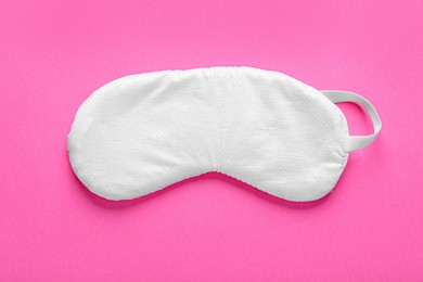 Photo of Soft sleep mask on pink background, top view