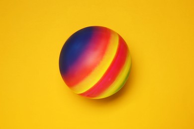 Photo of New bright kids' ball on orange background, top view