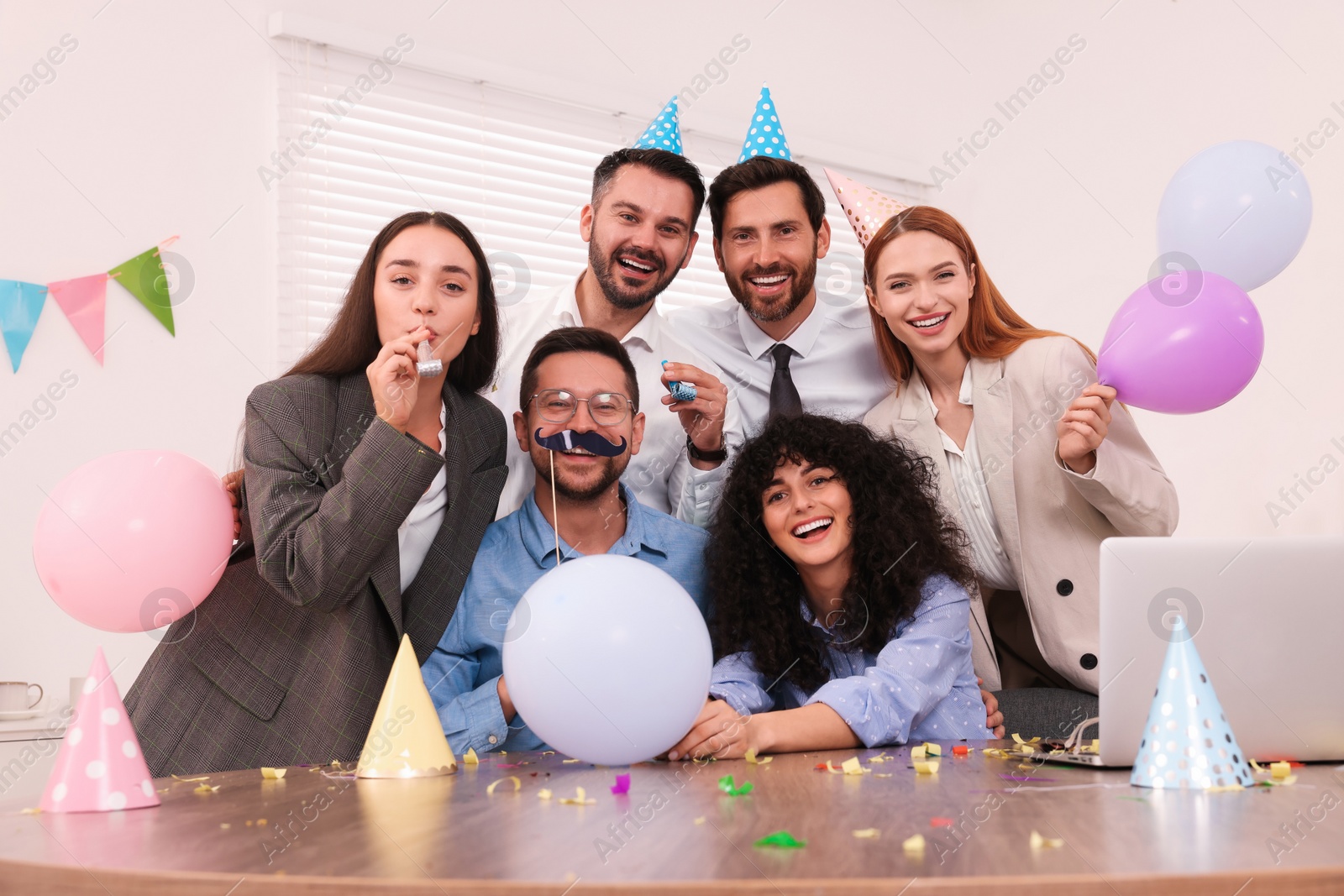 Photo of Coworkers having fun during office party indoors