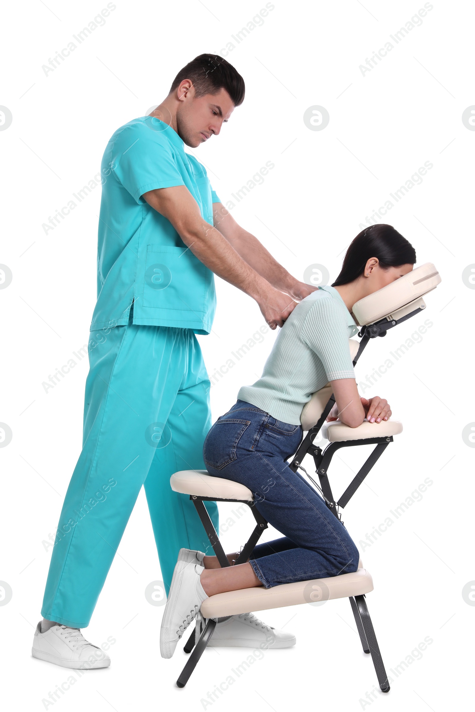 Photo of Woman receiving massage in modern chair on white background