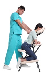 Photo of Woman receiving massage in modern chair on white background