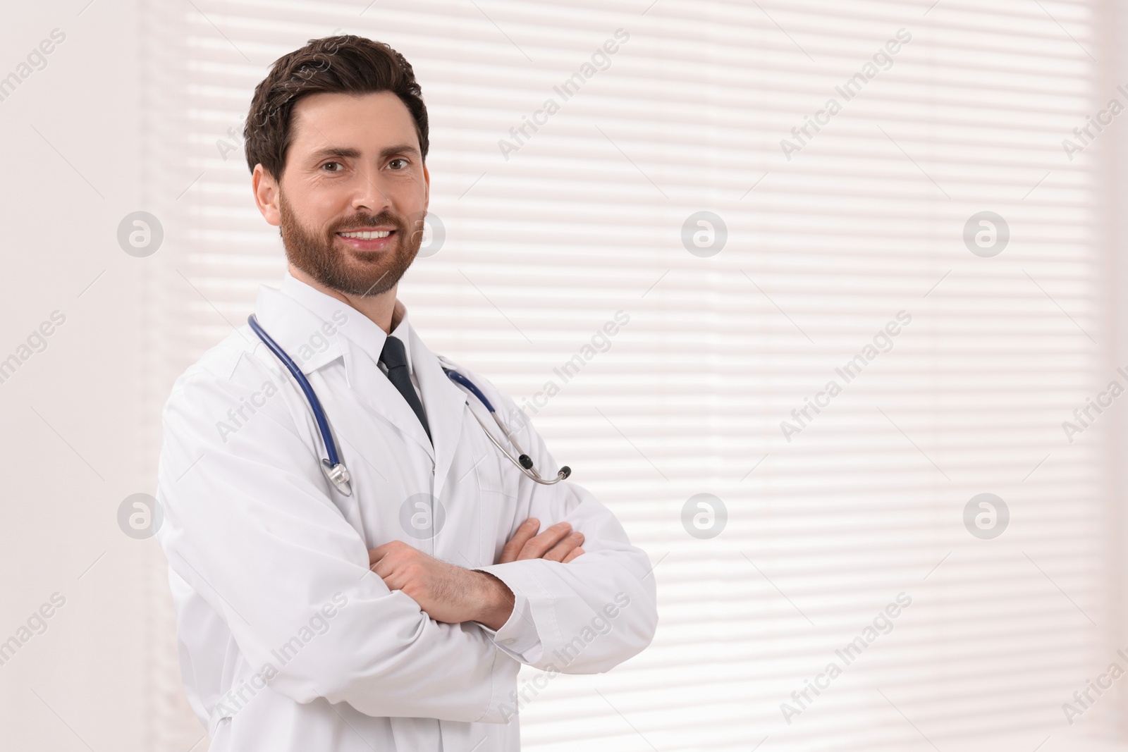 Photo of Medical consultant with stethoscope in clinic, space for text