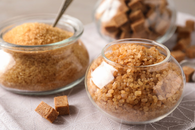 Photo of Glass bowls with brown sugar on table