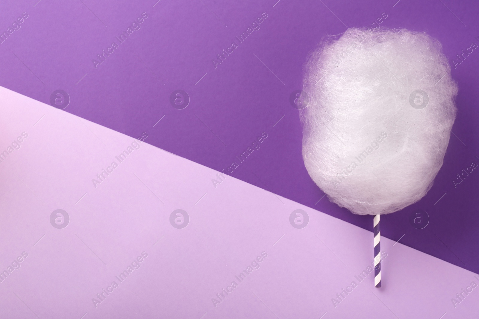 Photo of One sweet cotton candy on color background, flat lay. Space for text