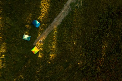 Image of Camping tents in forest on sunny day, top view. Drone photography 