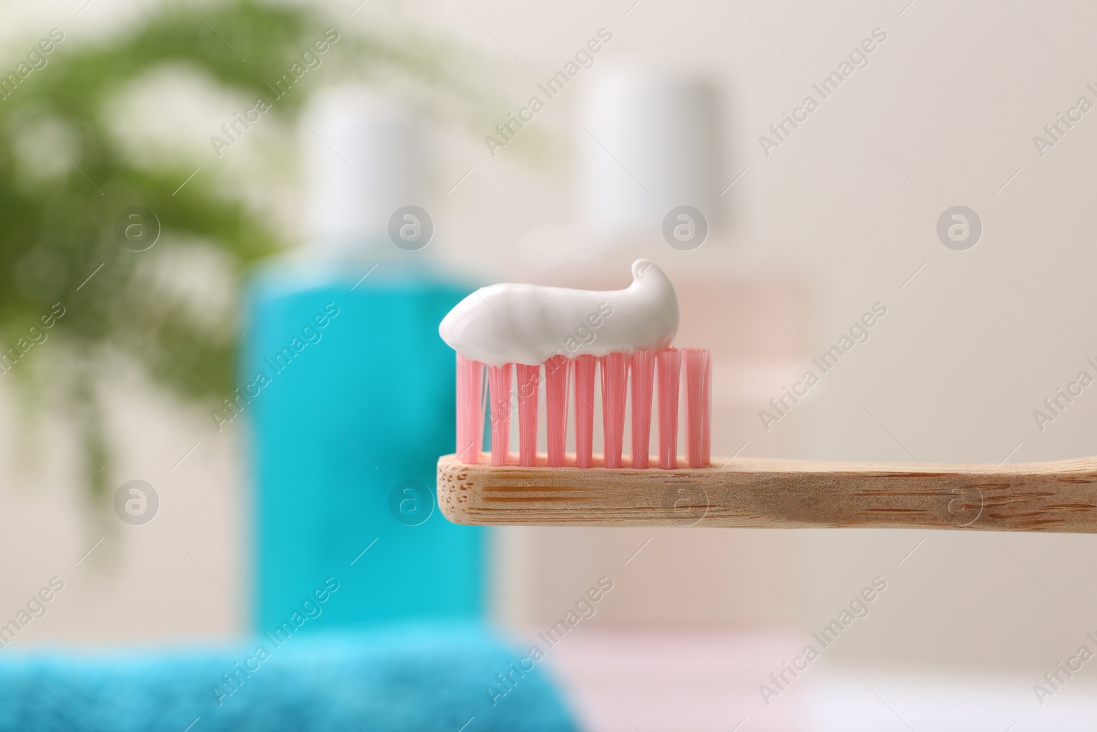 Photo of Brush with toothpaste on blurred background, closeup