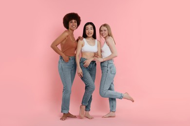 Photo of Portrait of beautiful young women on pink background. Space for text