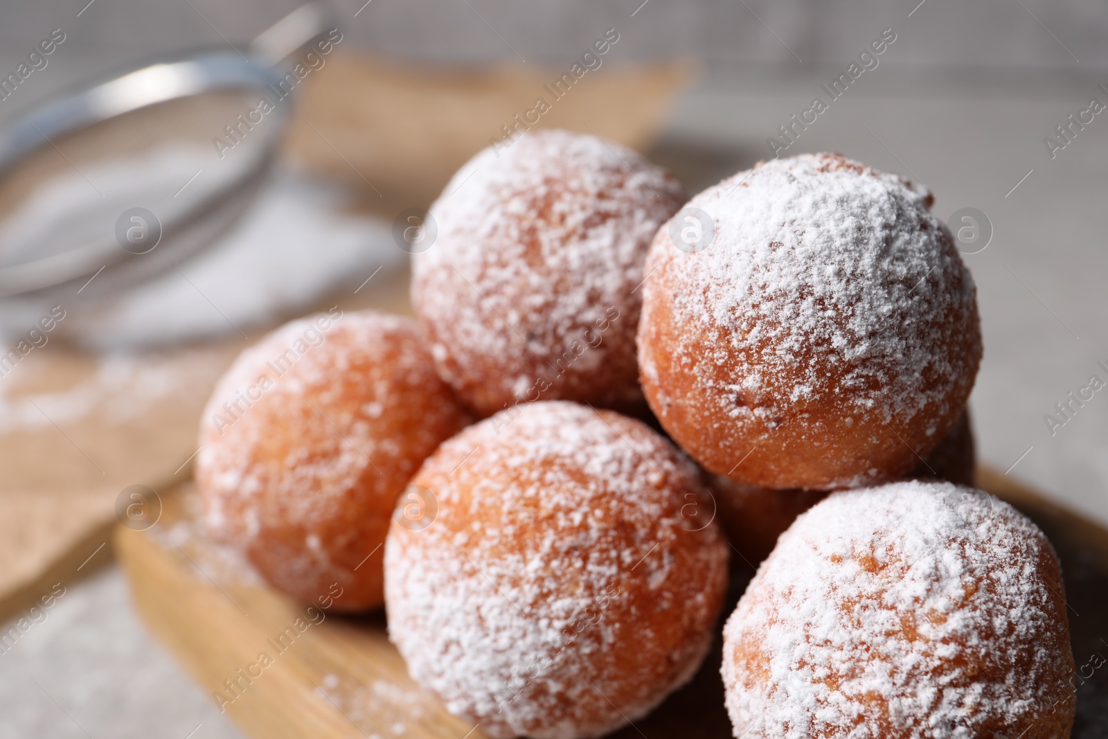 Photo of Delicious sweet buns with powdered sugar on table, closeup