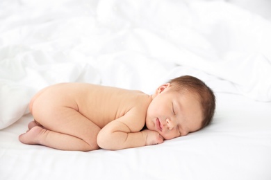 Photo of Adorable newborn baby sleeping on bed