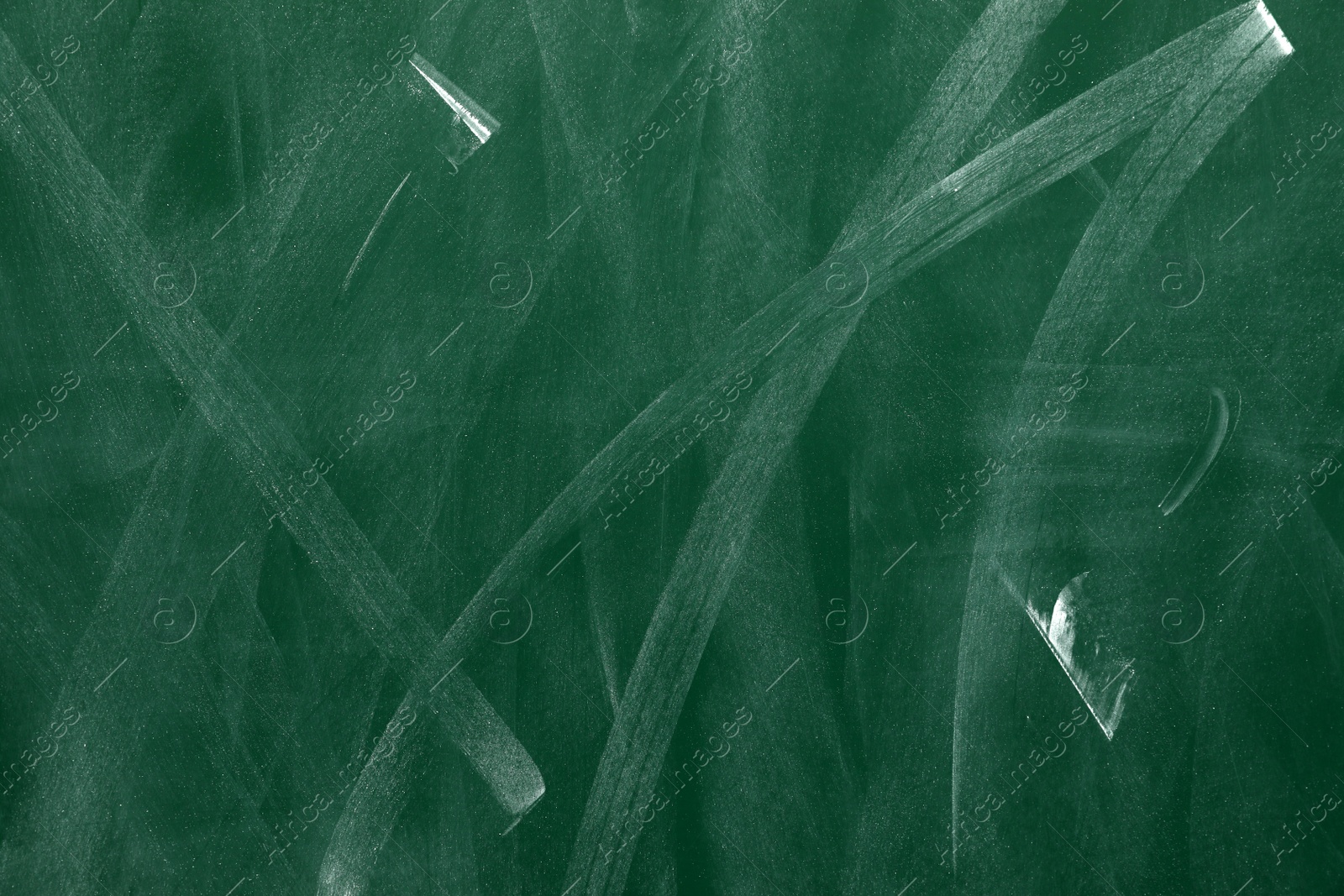 Photo of Dirty green chalkboard as background. School equipment