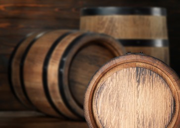 Wooden barrels in cellar, selective focus. Space for text