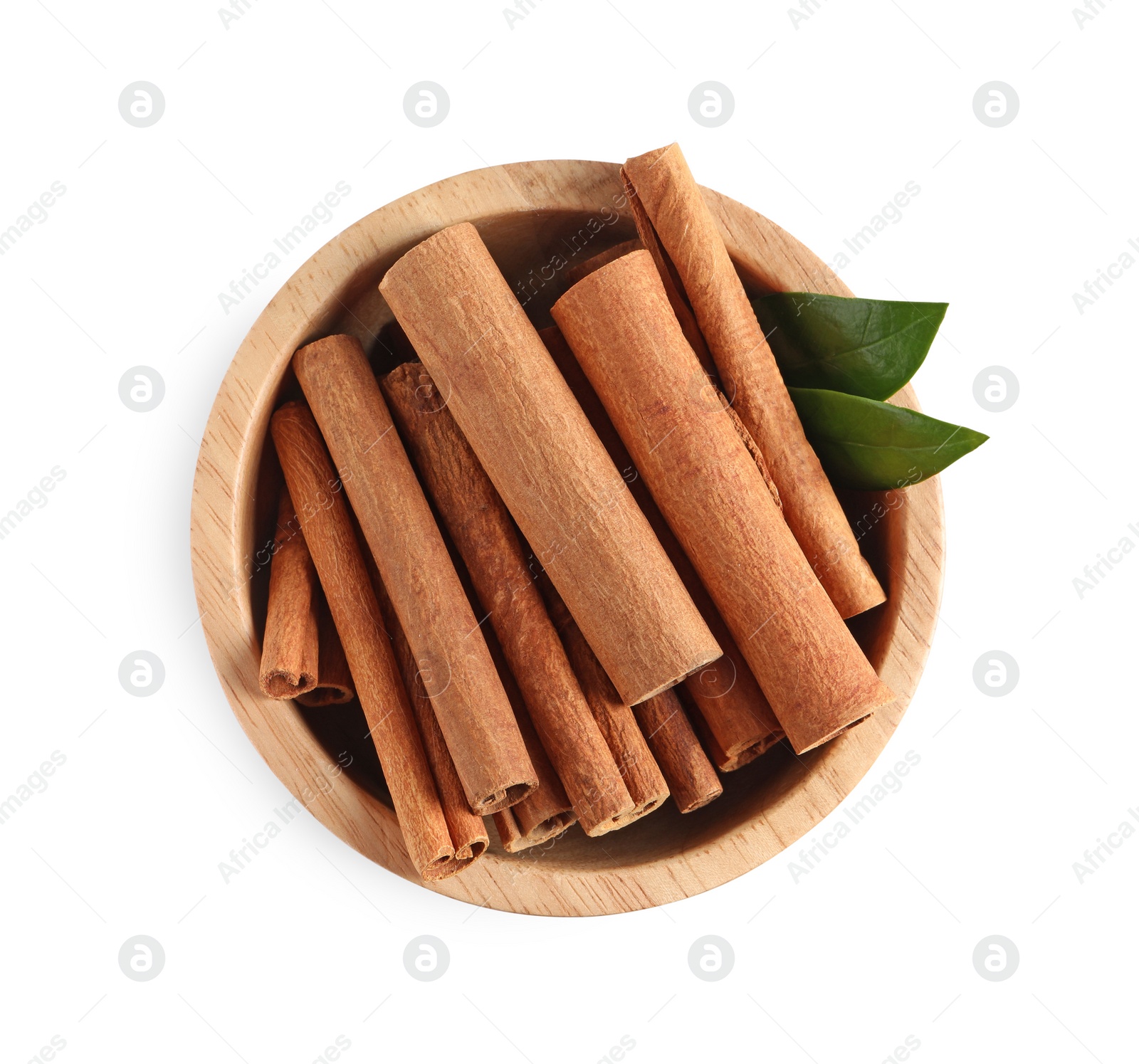 Photo of Cinnamon sticks and green leaves in bowl isolated on white, top view