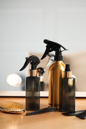 Photo of Set of hairdresser tools on table in salon