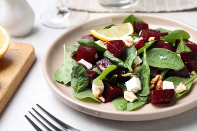 Photo of Delicious beet salad served on grey table, closeup