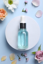 Photo of Bottle of cosmetic serum, beautiful flowers and petals on light blue background, flat lay