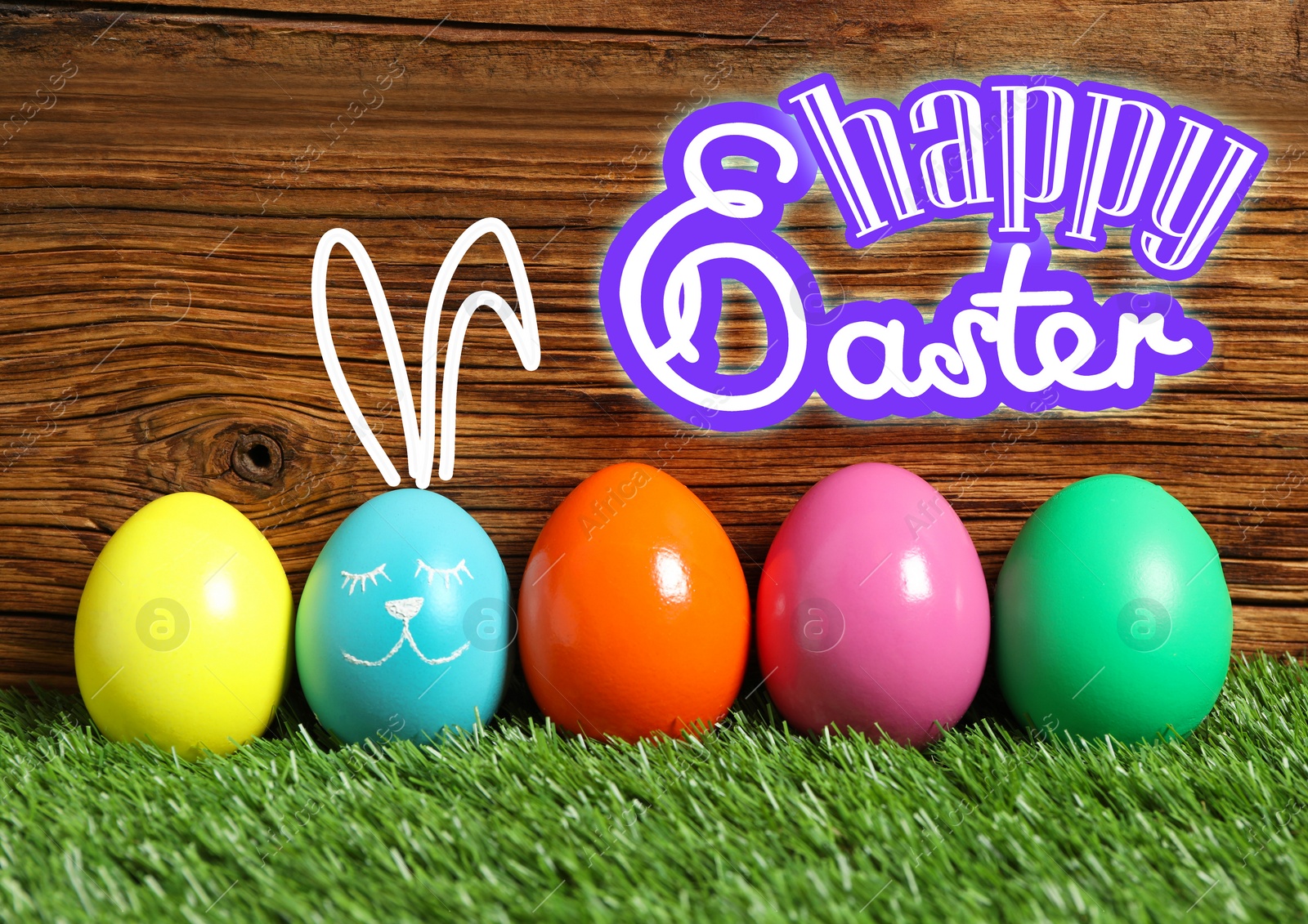 Image of Happy Easter. One egg with drawn face and ears as bunny among others on green grass against wooden background