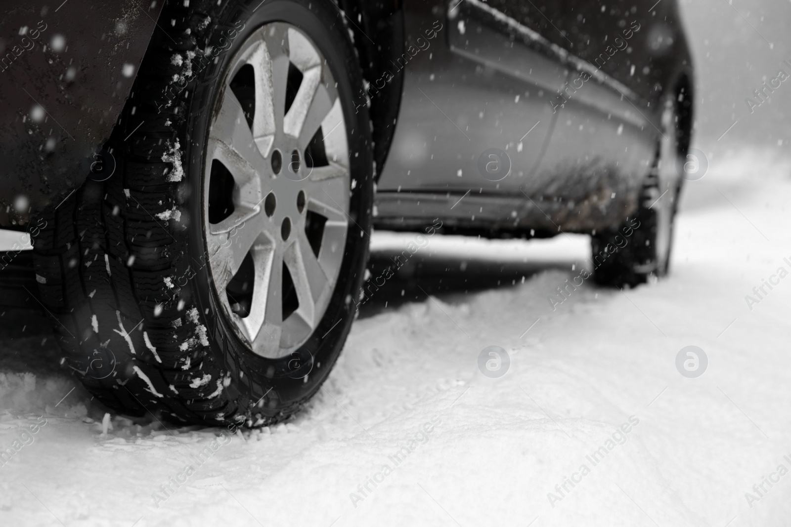 Photo of Country road with car on snowy winter day, closeup