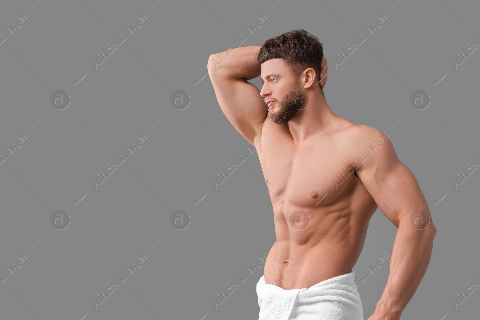 Photo of Handsome muscular man on grey background, space for text. Sexy body