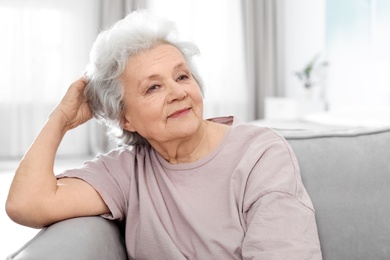 Photo of Portrait of mature woman in living room