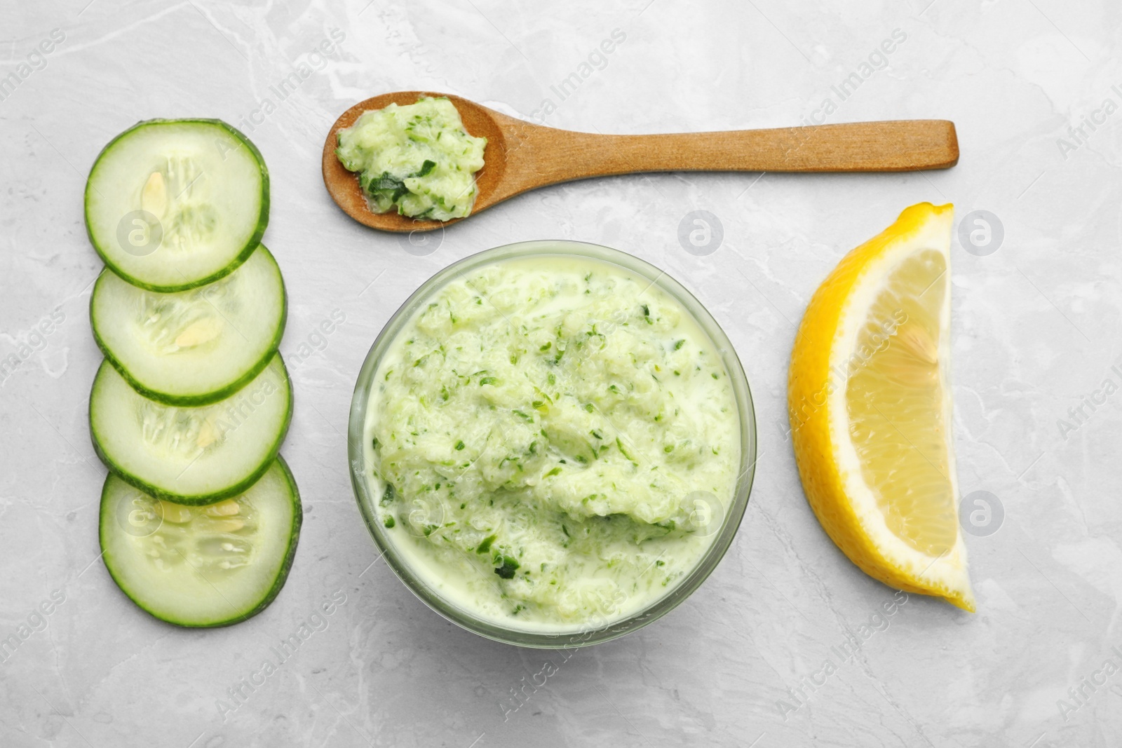 Photo of Handmade face mask and fresh ingredients on light marble table, flat lay