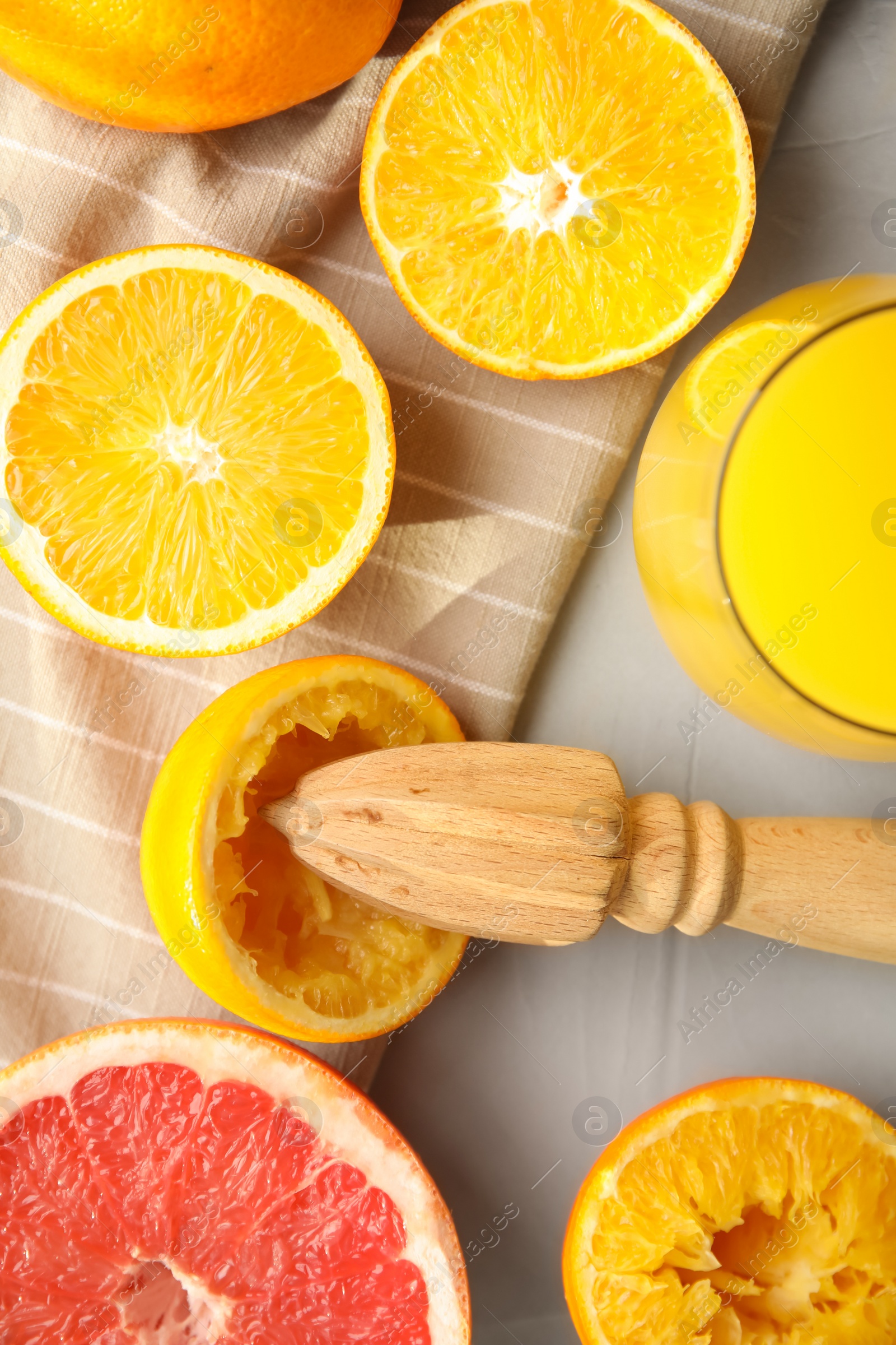 Photo of Flat lay composition with oranges and reamer on light grey table