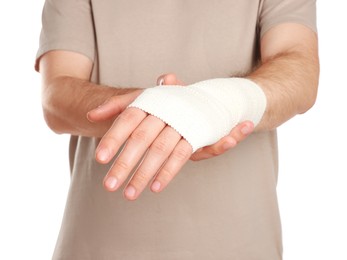 Photo of Man with hand wrapped in medical bandage on white background, closeup