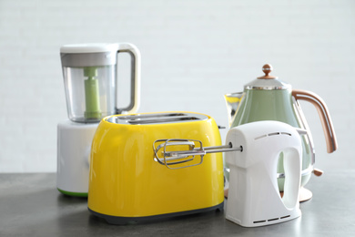 Photo of Set of modern home appliances on grey table