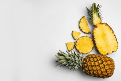 Photo of Composition with raw cut pineapples on white background, top view