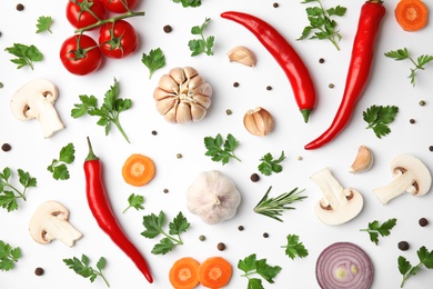 Flat lay composition with green parsley, peppercorns and vegetables on white background